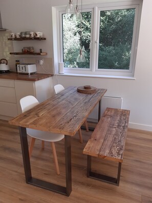 Handmade dining table for sociable meals. A high is available for younger diners