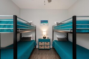 Cozy third bedroom with twin bunks and smart TV—perfect retreat for younger guests to relax and unwind.