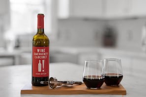 Relax with a glass of wine at the marble top kitchen bar