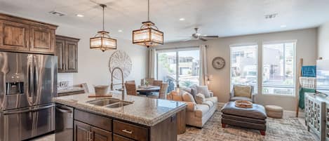 Kitchen View - The kitchen is fully stocked with all the dishes, cookware, baking pans, and cutlery you will need for meal preparations and includes stainless steel appliances and granite counter tops.