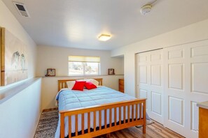 King bed with closet and dressers.