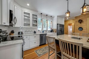 The new kitchen has granite countertops, new appliances and a farmhouse sink.