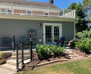 Private patio entrance overlooks the back garden and communal living areas.