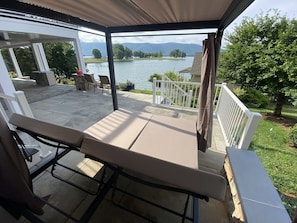 ....relax off to the side patio in a private cabana with four sided curtains
