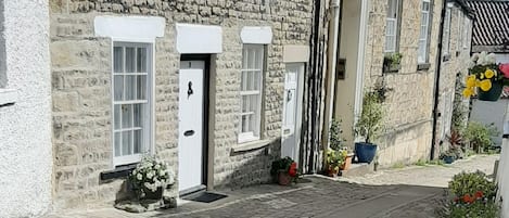 Tower Street.  Property is second white door on left