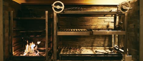 The main wood-fired grill. You will eat the exquisite course meal cooked here.