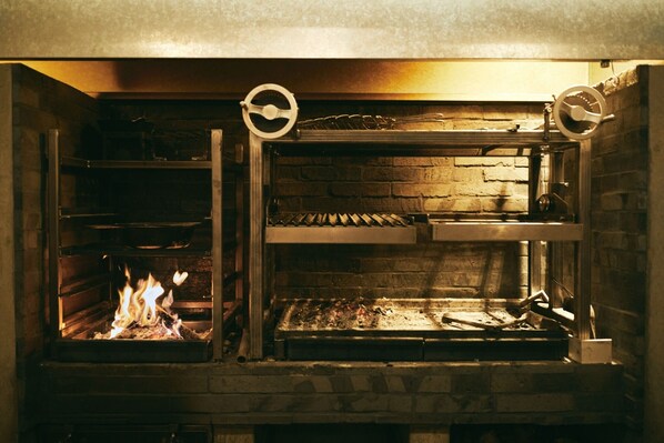 The main wood-fired grill. You will eat the exquisite course meal cooked here.