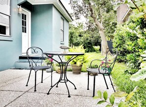 Outdoor seating area with cafe seating off kitchen. 