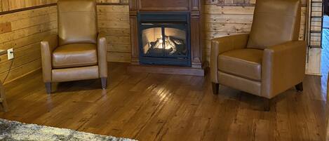 Push button gas fireplace and two leather recliners in the living room.