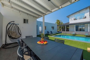 Our poolside table and chairs set the scene for unforgettable moments with friends and family.