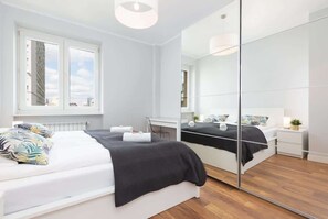 The cosy bedroom provides a peaceful night's sleep on the double bed opposite which there is a large wardrobe with mirrored doors. Next to the wardrobe there is a desk. 