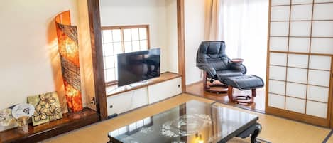 Spacious Japanese Tatami room used as living room with 'Engawa' which is facing the balcony. You can enjoy television (Netflix) here.