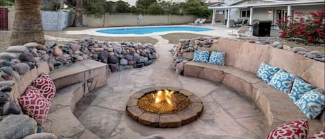 Large fire pit area with seating for up to 10 people