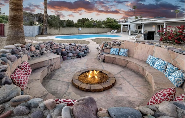 Large fire pit area with seating for up to 10 people