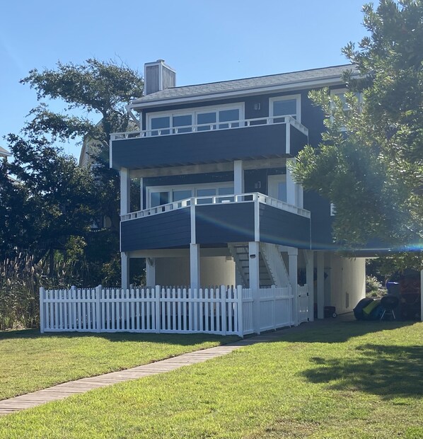 The back of the house/fenced yard/walkway leading to dock.  