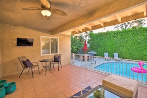 The vacation rental features a furnished patio with an outdoor flat-screen TV.