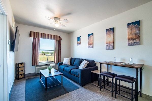 Modern living space with 58" flatscreen TV and cable with HBO. This couch folds out into a queen size bed and we provide extra linens. This 1bd sleeps up to 4 comfortably.