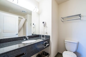 Stylish bathroom with granite countertop, hair dryer, towels and everything you will need for your stay.