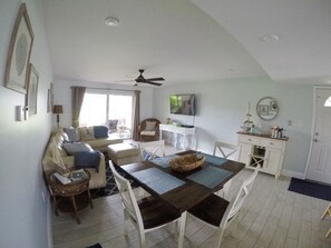 Main living space with leather sectional sofa and dining area