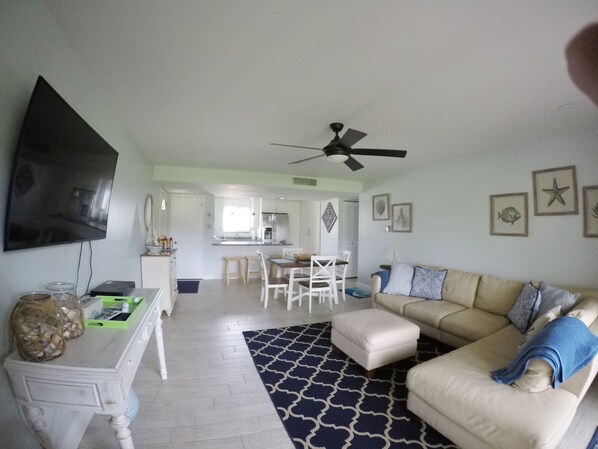 Main living space with leather sectional sofa and dining area