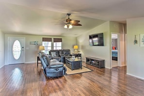 The living room features a large flat-screen cable TV.