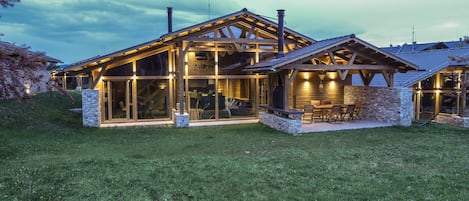 Back of chalet with panoramic windows, patio and private BBQ