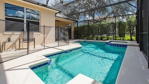 Dive into your private pool oasis, surrounded by lush greenery and total privacy.