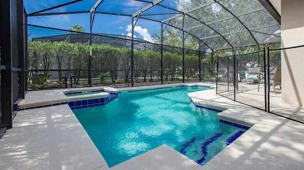 Relax by the screened-in private pool, perfect for sunny days and peaceful evenings.