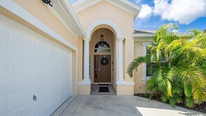 Welcoming front entry with charming architectural details and a warm vibe.
