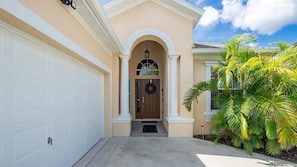Welcoming front entry with charming architectural details and a warm vibe.