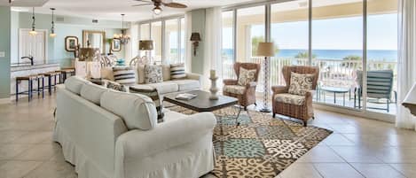 Spacious living room with floor to ceiling windows viewing the Gulf.