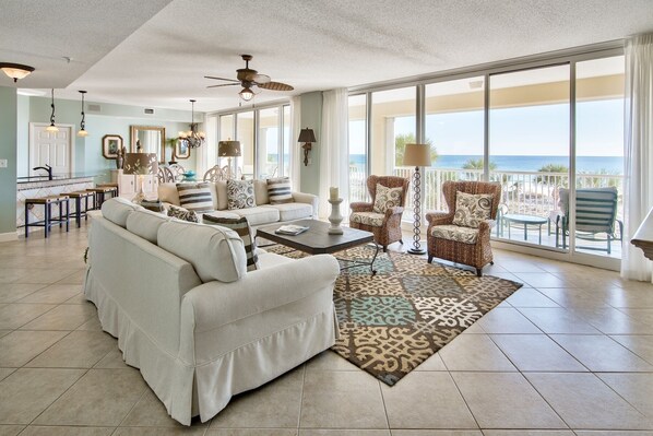 Spacious living room with floor to ceiling windows viewing the Gulf.