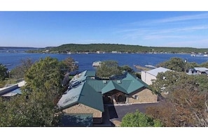 Aerial view of house, dock, and lake