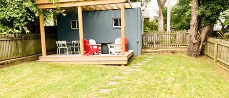 Relax on the new back deck in the fenced-in backyard.