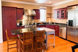 The spacious gourmet kitchen has high-end stainless steel appliances.