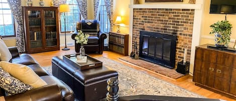 Welcome to the warm family room with a wood-burning fireplace