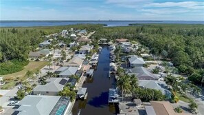 Aerial view of wide direct access canal that house is on.