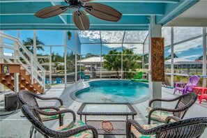 View of pool from seating under lanai.