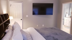 Master suite with on-suite full bathroom and 65 inch smart-TV 