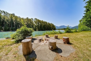 Relax in the fully private front yard where you can dip your feet in the river.