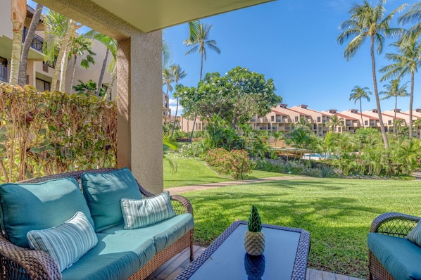 Private lanai with lush tropical views and comfortable outdoor seating