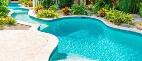 Our custom lazy river connects two gorgeous pools in the back yard!