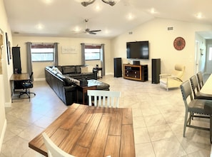 Main living room with 75 inch TV and surround sound