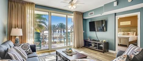 Living room with sleeper sofa and entrance onto the extra large balcony!