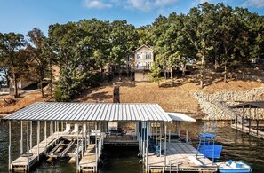 Private dock in cove with large swim platform and boat slip for guest to use.