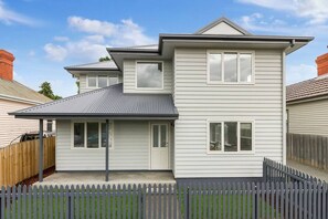 The home's contemporary exterior blends style and functionality, offering a welcoming first impression and off-street parking for convenience.