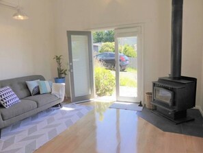 Upon entry, you'll find the living area where you can settle with a movie while a wood-burning fireplace keeps you cosy. 
