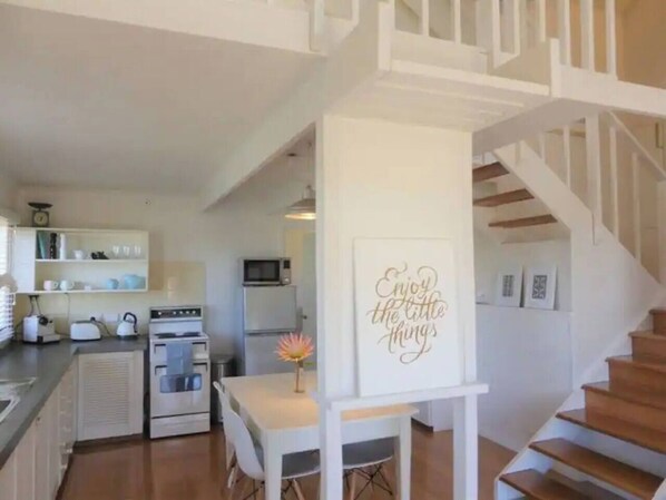 The kitchen and dining area is downstairs for your convenience. There's room for everyone around the central dining table.