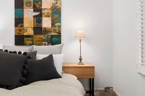 Enjoy optimal sleeping conditions with light-filtering shutters and settle in with the convenience of a TV and hanging storage.