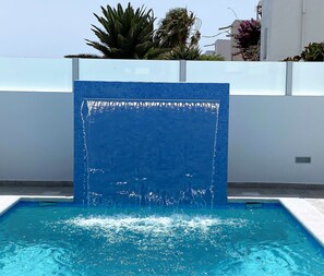 Pool with feature waterfall and swim jets.